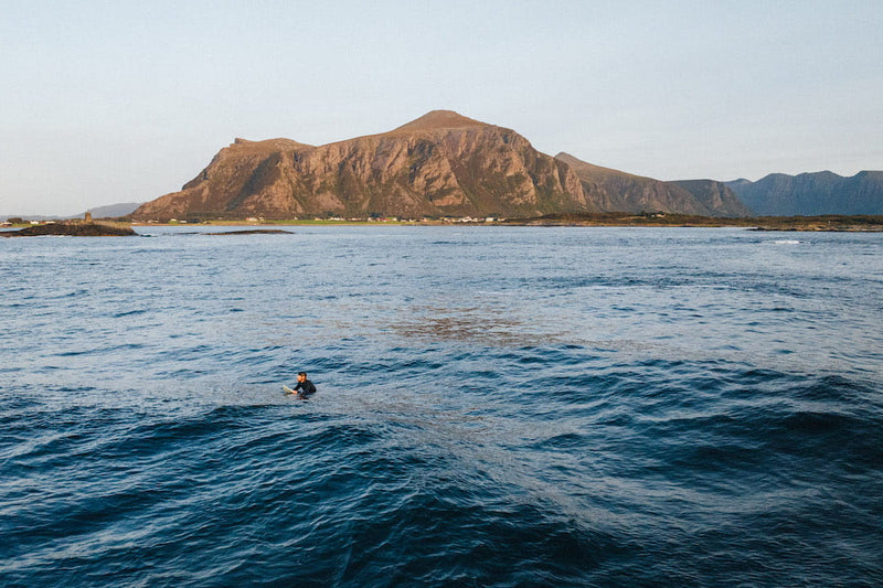 Surfer wearing Sjo Protection soft surf helmet in the ocean