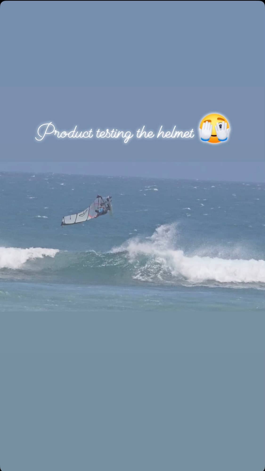 A windsurfer is doing loops on his windsurf board and crashing while wearing the Sjø Protection soft surf helmet.