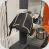 A soft surf helmet is being penetration tested in a lab. This prototype does not have the protective Kevlar layer. The sharp projectile being dropped penetrates all the way through the helmet.
